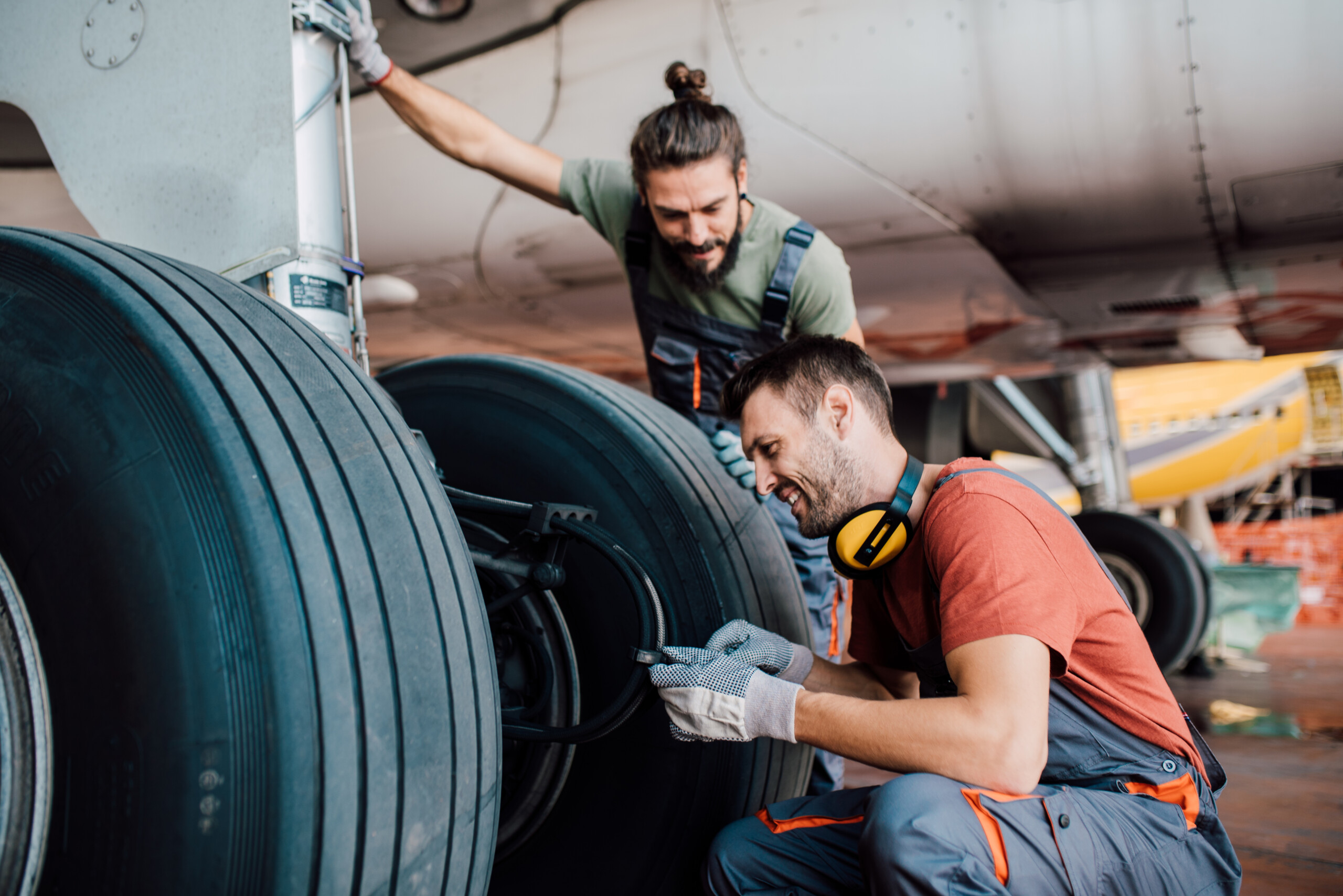 Happy people repairing an aircraft