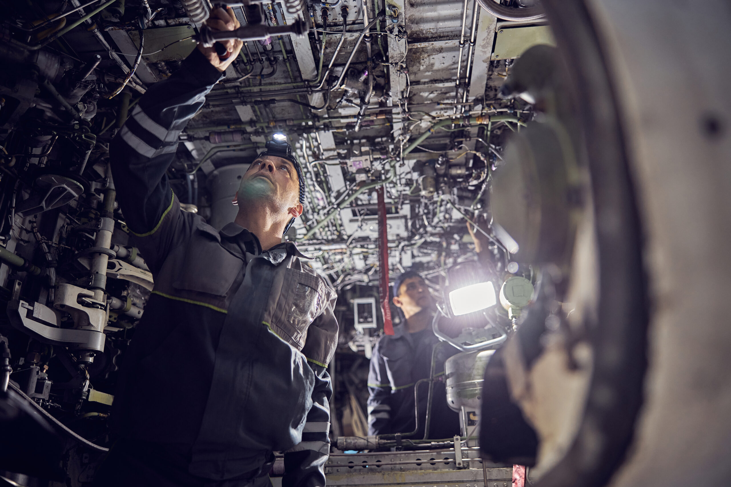 Aircraft worker repairing airplane in the indoors